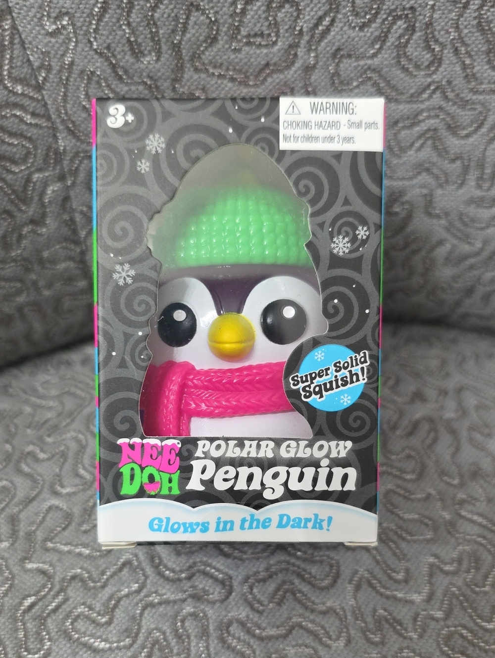 NeeDoh Polar Glow Penguin Squishy - Pink Scard & Green Hat